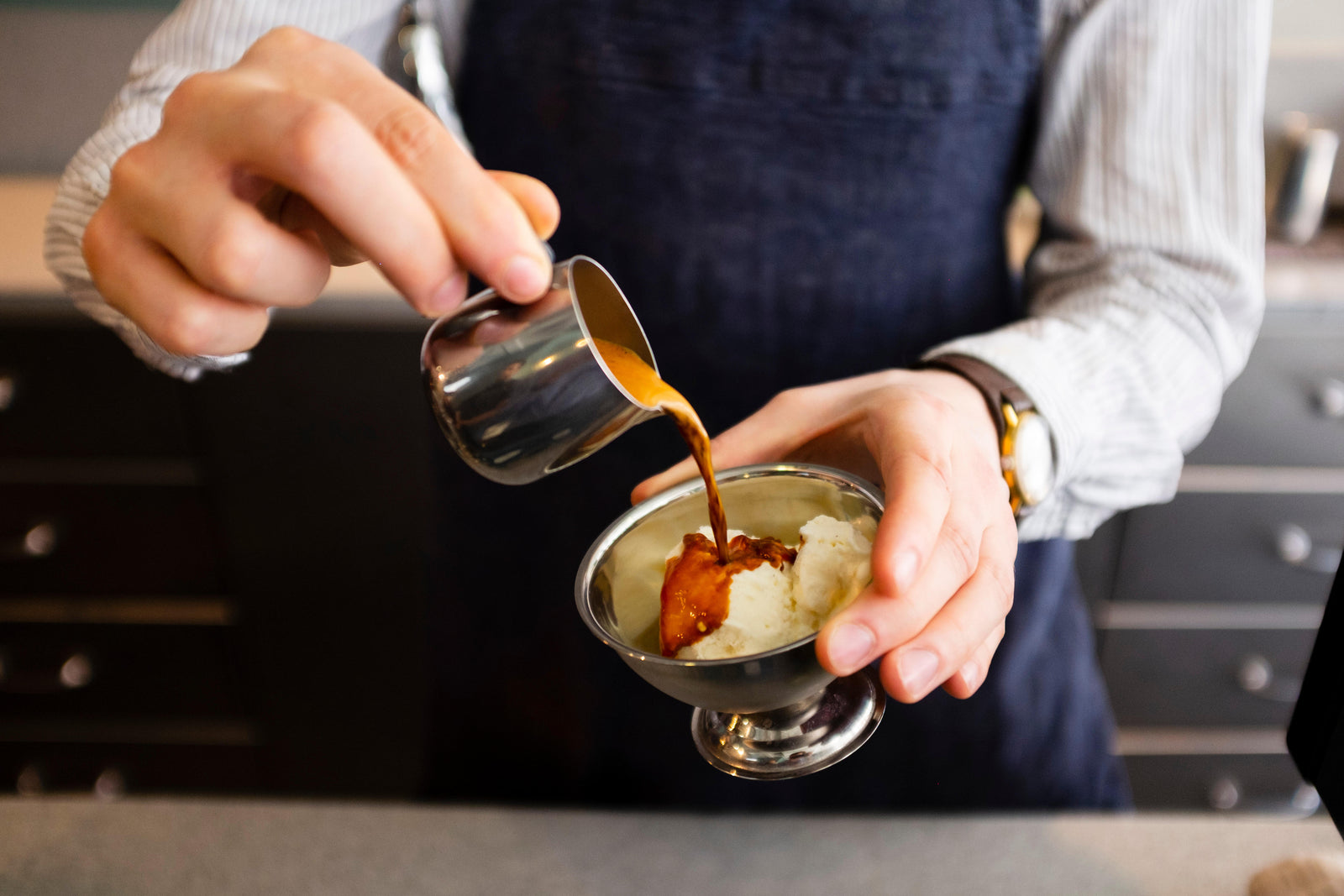 barista pouring affogato