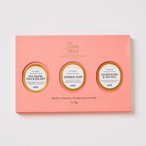 Pink chocolate bar collection packaging with three round labels on a white background