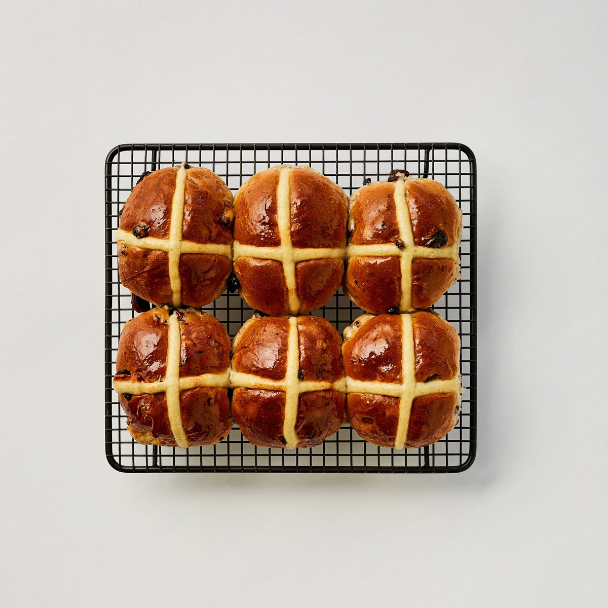 six hot cross buns on a tray