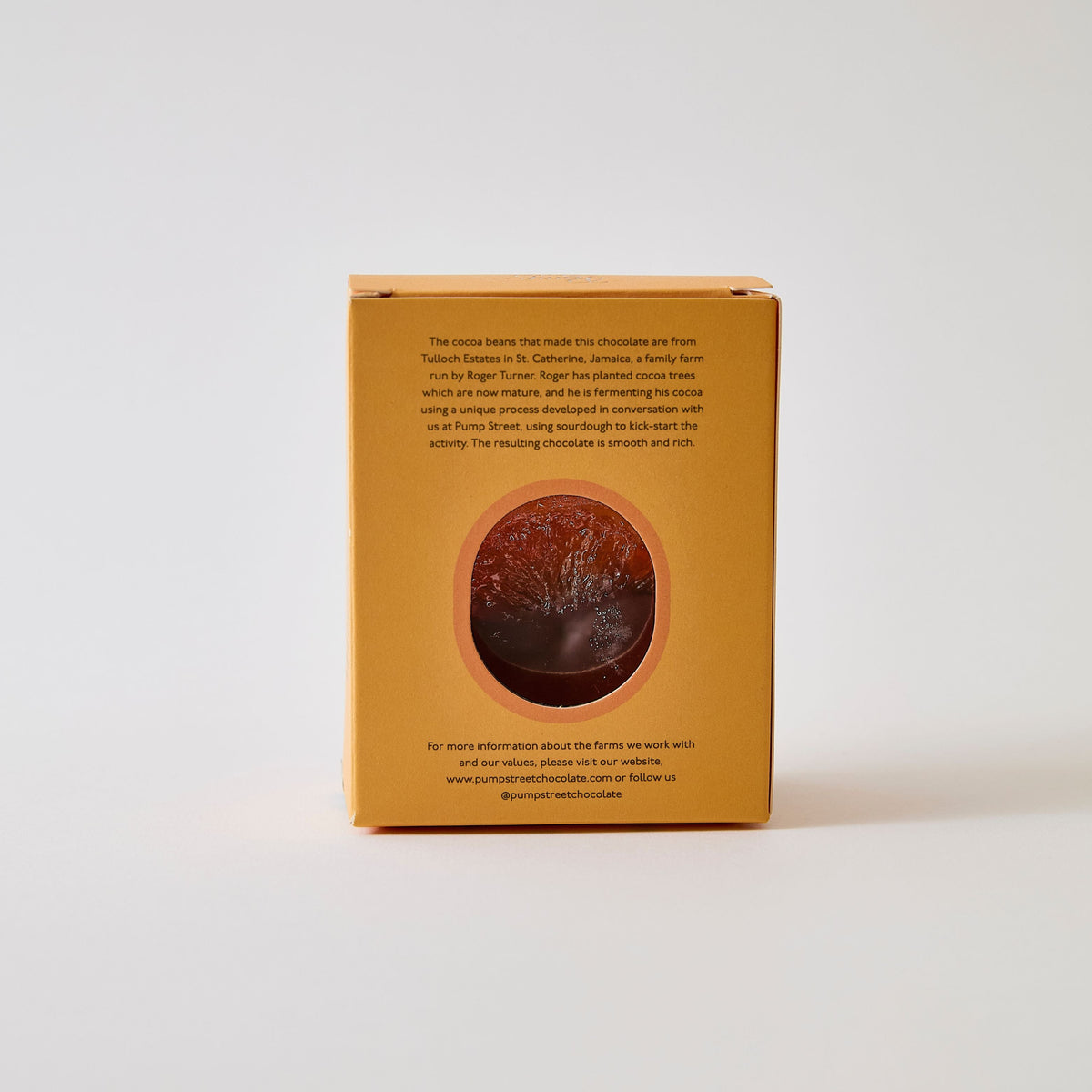 Back of orange box, with an oval window cut out displaying the orange inside