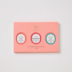 Pink chocolate bar collection packaging with three circular labels on a light gray background