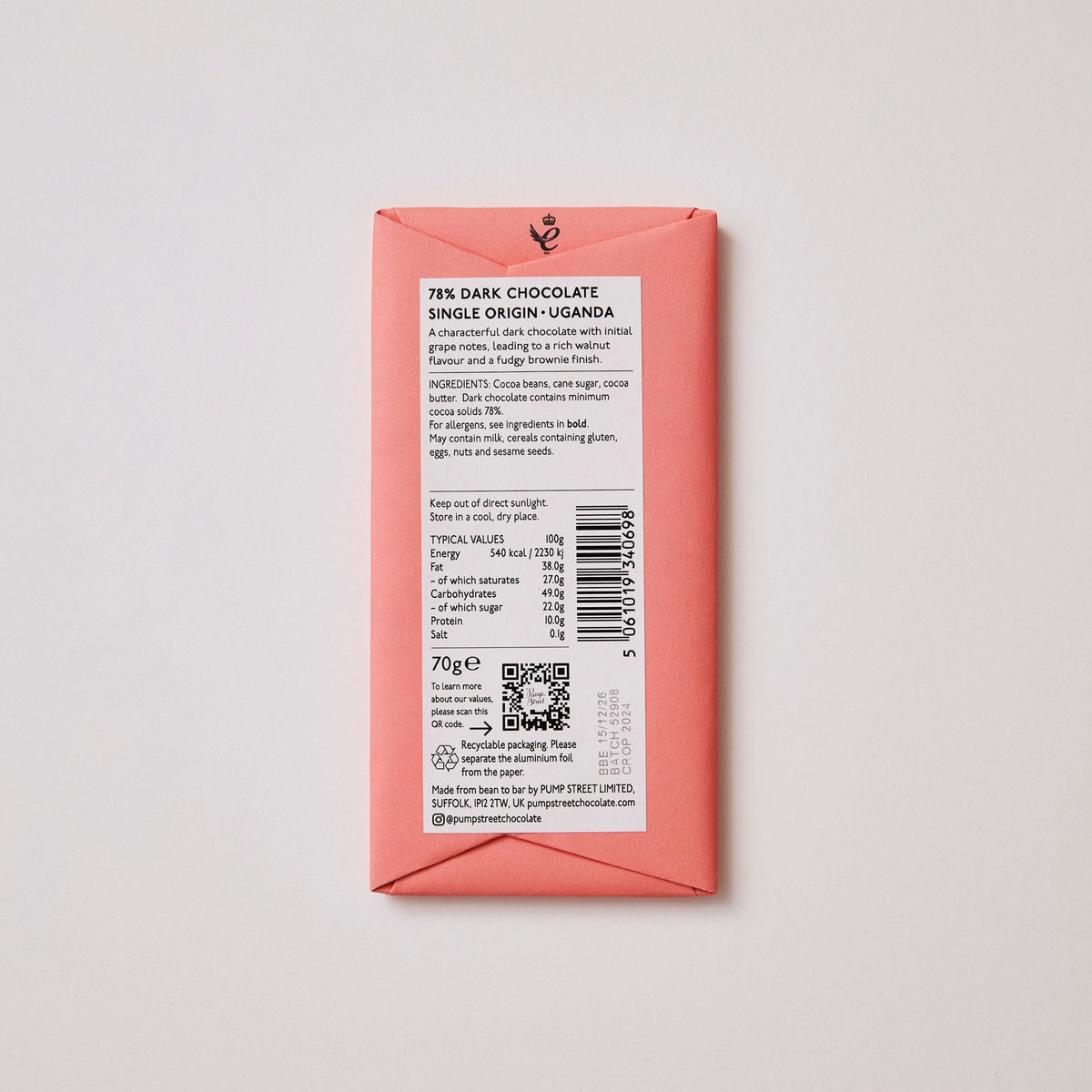 Back of a chocolate bar packaging with text and a barcode on a light gray background