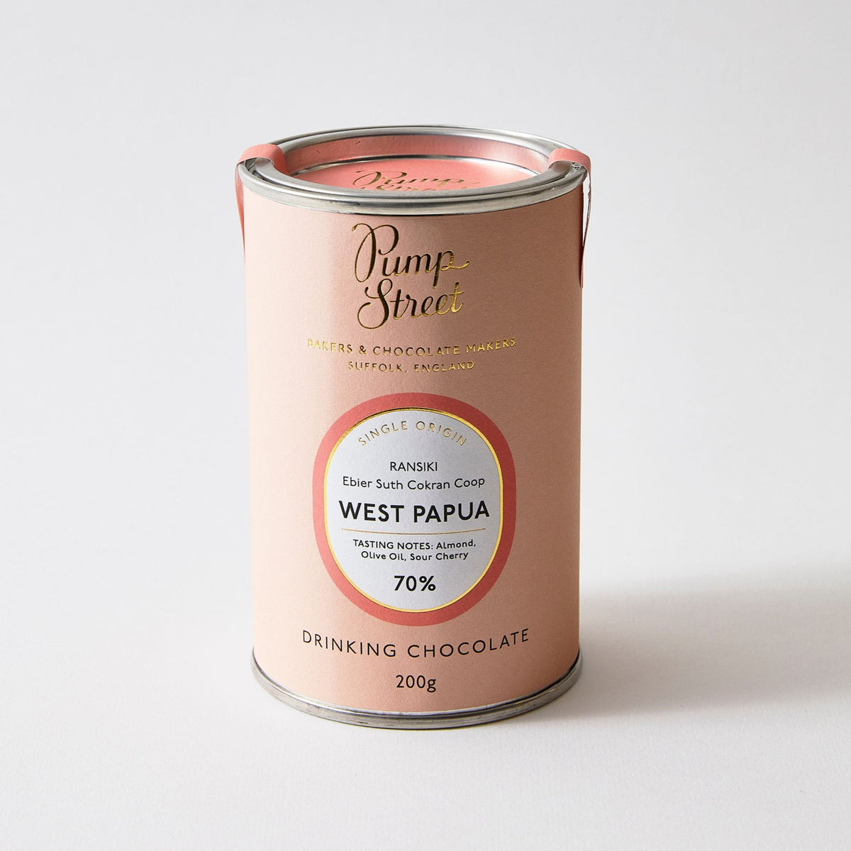 Pink tin of drinking chocolate on a plain white background